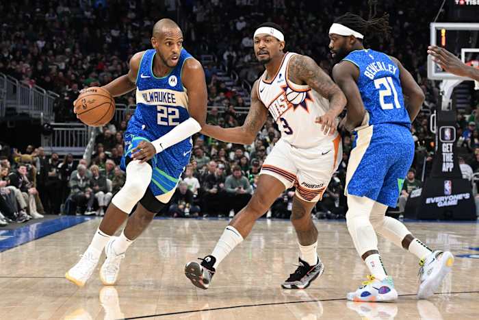 Milwaukee Bucks forward Khris Middleton (22) drives to the basket against Phoenix Suns guard Bradley Beal (3)